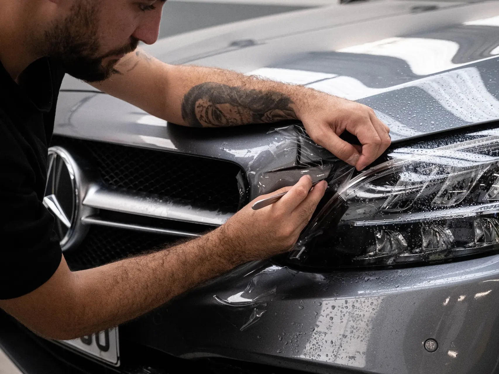 a man waxing the hood of a car